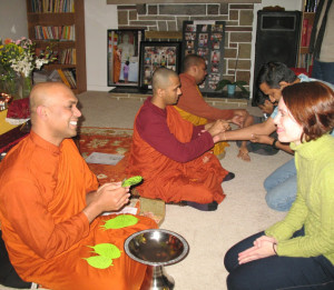 Monks and people in a blessing ceremony.